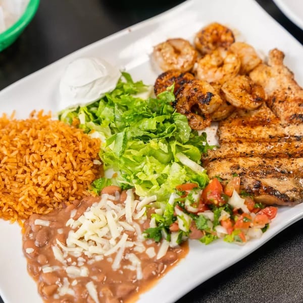 Grilled chicken and shrimp with rice, beans, lettuce, pico de gallo, and sour cream.